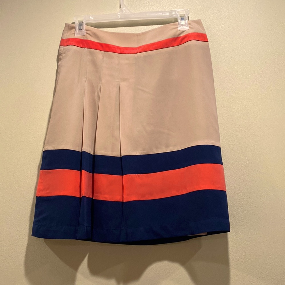 Very soft lined skirt with three pleads on the side. Size 4